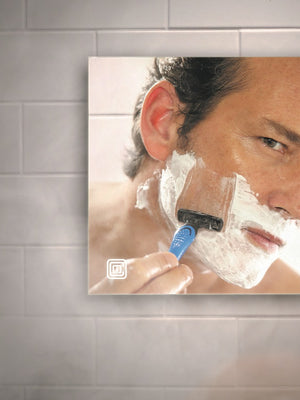 Man shaves in the shower with Clarity fog-free mirror from ClearMirror